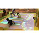 innvovative interactive system with a lot of kids playing piano
